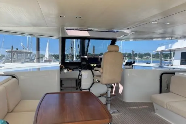 Slide: The Image of Interior of a 2015 Gunboat 57' yacht with helm, seating, and table. - 11