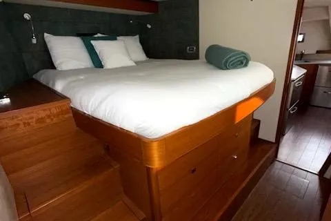 Slide: The Image of Luxurious bedroom interior of 2015 Gunboat 57' yacht with wooden furnishings and cozy bedding. - 16