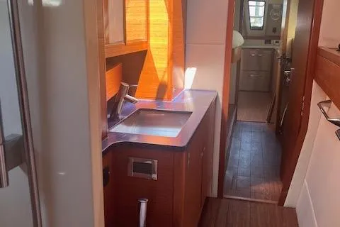 Slide: The Image of Interior of a 2015 Gunboat 57' yacht featuring a modern kitchen area. - 17