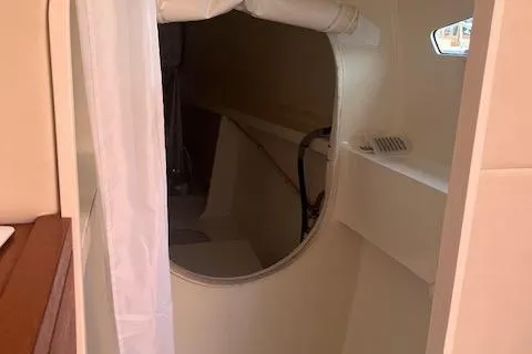 Slide: The Image of Interior view of a 2015 Gunboat 57' yacht, featuring a circular doorway and sleek design. - 18