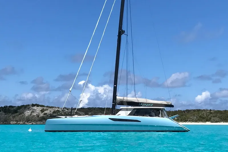 Slide: The Image of 2015 Gunboat 57' catamaran sailing in clear turquoise waters under a bright blue sky. - 2