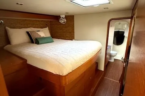 Slide: The Image of Luxurious cabin interior of 2015 Gunboat 57' yacht with cozy bed and ensuite bathroom. - 21
