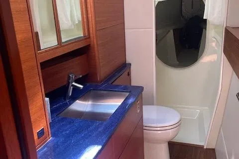 Slide: The Image of Luxurious bathroom in a 2015 Gunboat 57' yacht with modern fixtures and wood accents. - 24