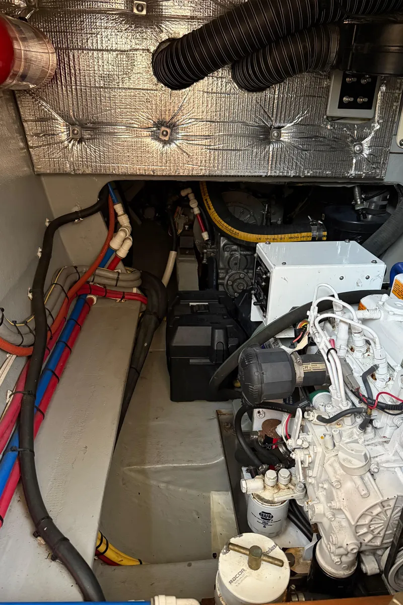 Slide: The Image of Engine room of a 2015 Gunboat 57' yacht, showcasing mechanical components and wiring. - 26