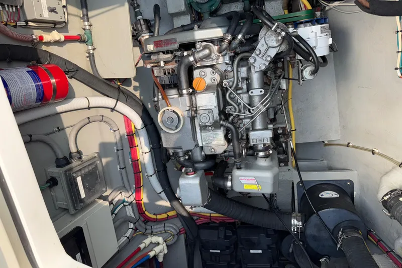 Slide: The Image of Engine compartment of a 2015 Gunboat 57' yacht, showcasing mechanical components and wiring. - 27