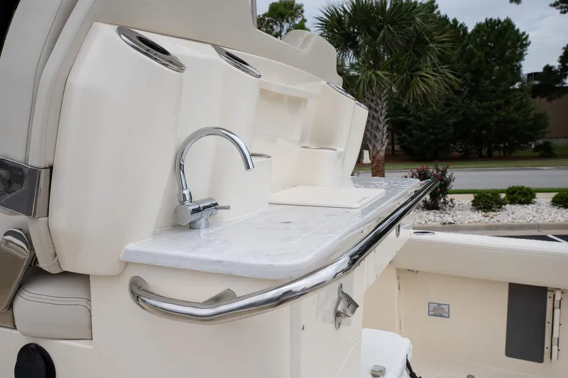 Slide: The Image of 2026 Scout 288 LXF boat interior with sink and cup holders. - 11