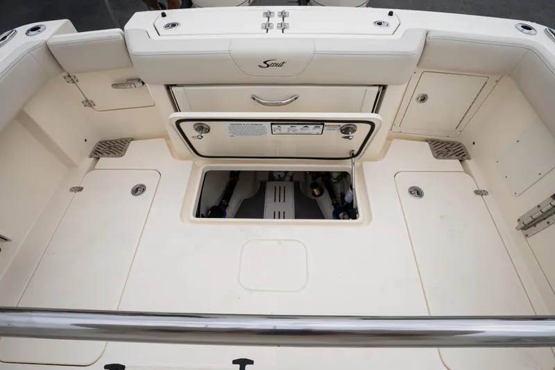 Slide: The Image of 2026 Scout 288 LXF boat interior with open storage compartments and clean deck design. - 18