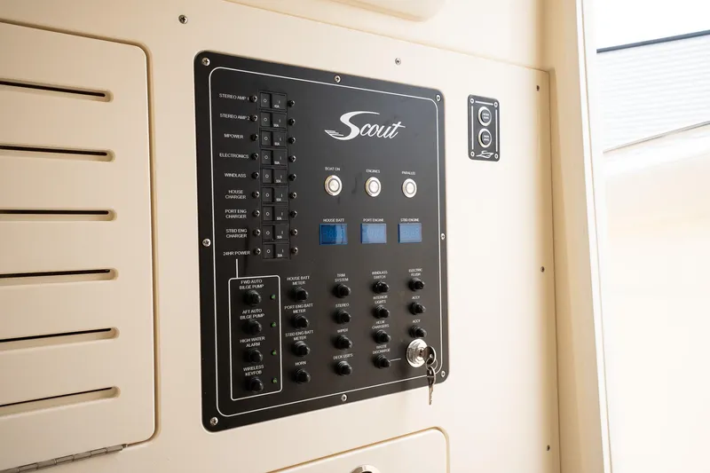 Slide: The Image of Control panel of 2026 Scout 288 LXF boat, featuring various switches and indicators. - 38