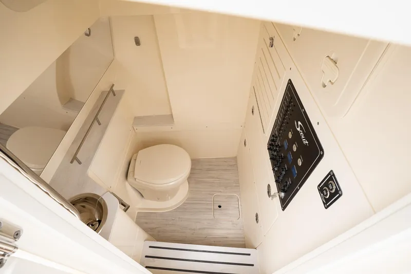 Slide: The Image of 2026 Scout 288 LXF boat interior with toilet and control panel. - 45