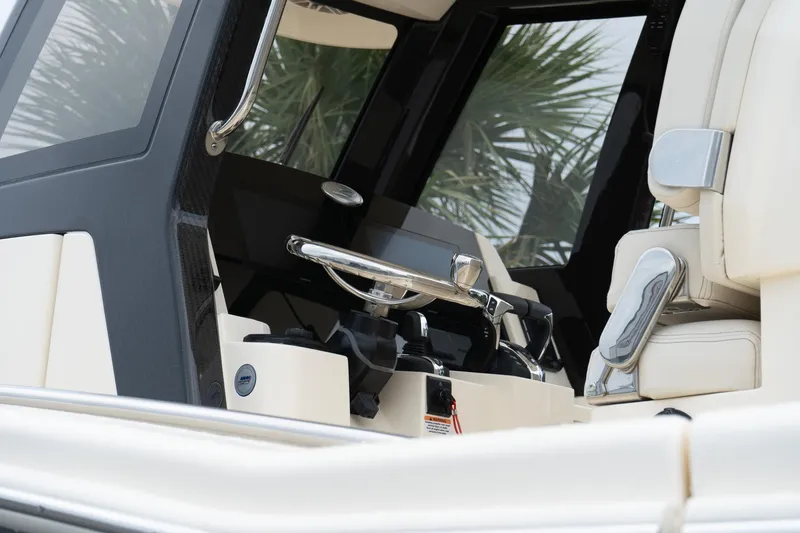 Slide: The Image of 2026 Scout 288 LXF boat interior with steering wheel and seating. - 52