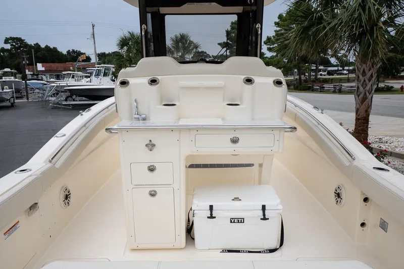 Slide: The Image of 2026 Scout 288 LXF boat interior with storage, sink, and Yeti cooler. - 9