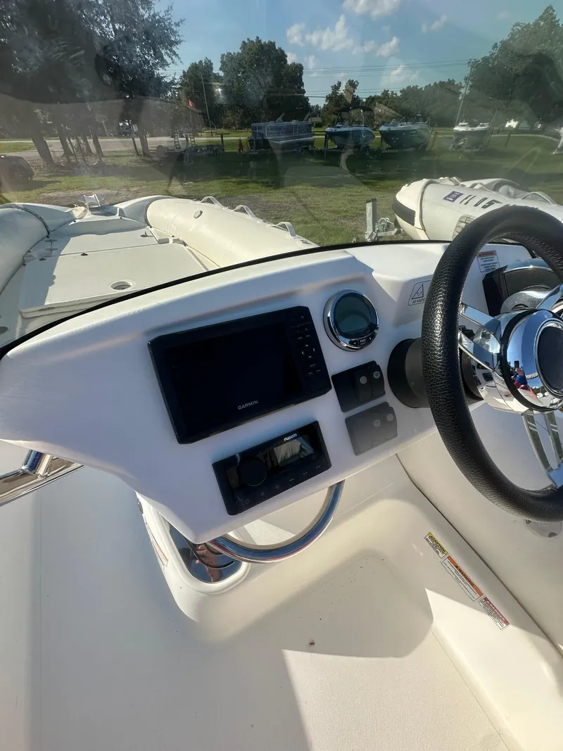 Slide: The Image of 2023 Zodiac N-ZO 680 boat dashboard with steering wheel and navigation system. - 5