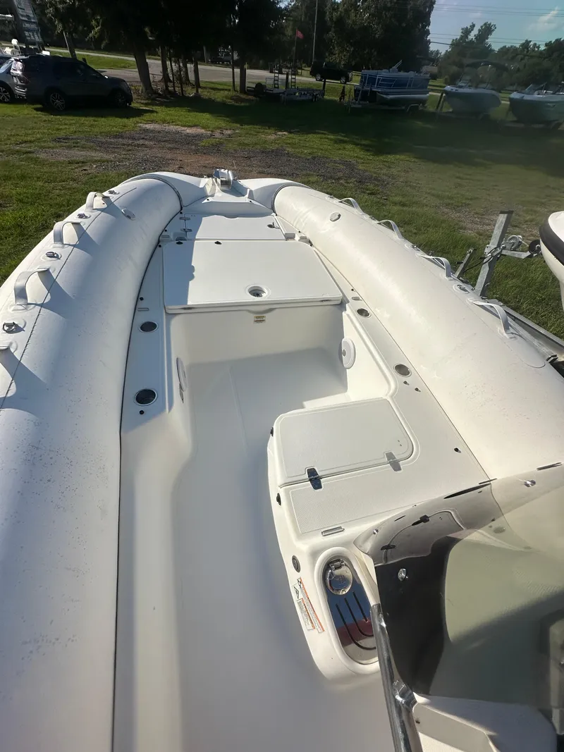 Slide: The Image of 2023 Zodiac N-ZO 680 inflatable boat, white interior, parked on grass. - 6