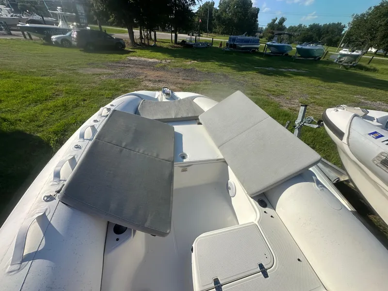 Slide: The Image of 2023 Zodiac N-ZO 680 boat with cushioned seating, parked on grassy area. - 7