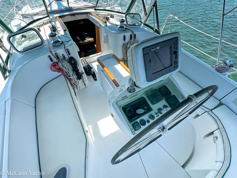 Slide: The Image of Cockpit of 1999 Beneteau 411 sailboat with navigation equipment and steering wheel. - 10