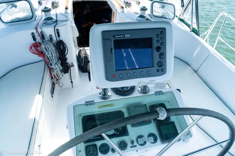 Slide: The Image of Cockpit of 1999 Beneteau 411 yacht with navigation equipment and steering wheel. - 11