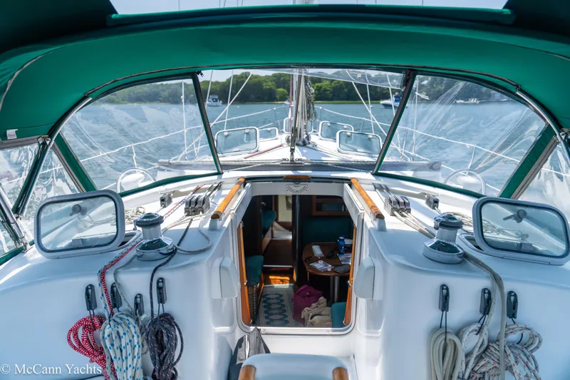 Slide: The Image of Cockpit view of a 1999 Beneteau 411 sailboat with green canopy and ropes. - 13