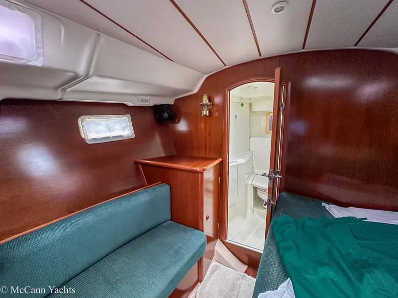 Slide: The Image of Interior of 1999 Beneteau 411 yacht cabin with wood finish and seating. - 23