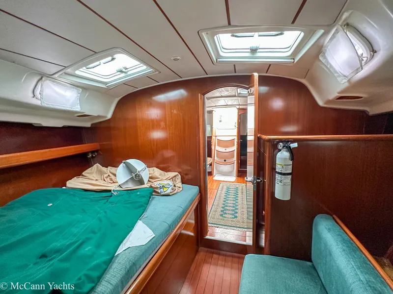 Slide: The Image of Interior cabin of a 1999 Beneteau 411 yacht with wooden finish and seating. - 28