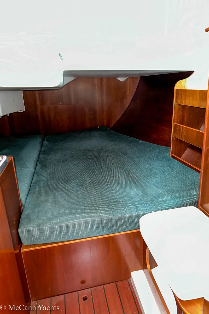 Slide: The Image of Interior cabin of 1999 Beneteau 411 yacht with wooden finish and cozy bedding. - 34