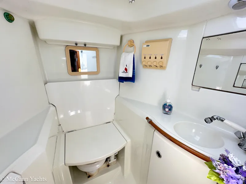 Slide: The Image of Bathroom interior of a 1999 Beneteau 411 yacht, featuring sink and toilet. - 38