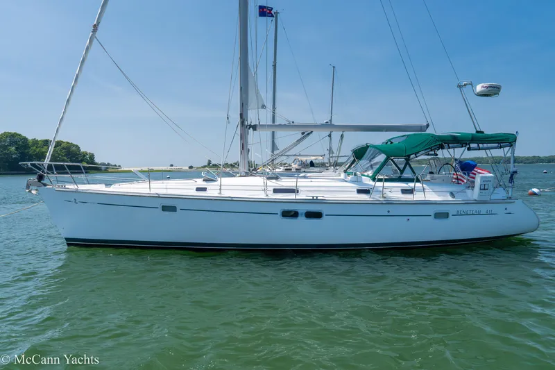 Slide: The Image of Sailing yacht Beneteau 411, 1999 model, anchored on calm waters under clear blue sky. - 4