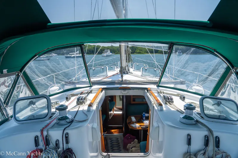 Slide: The Image of Cockpit view of 1999 Beneteau 411 sailboat with green canopy on calm water. - 44