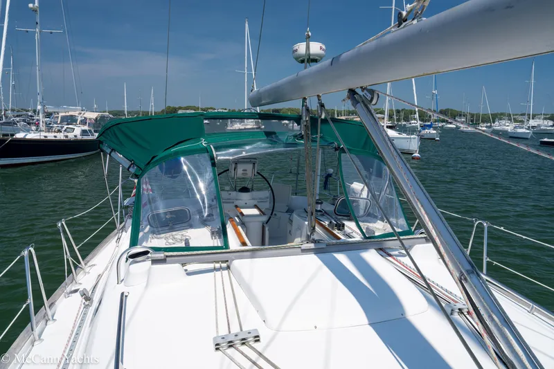 Slide: The Image of Sailing yacht Beneteau 411, 1999 model, docked in a marina under clear blue skies. - 45