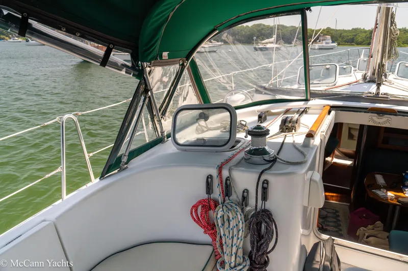 Slide: The Image of Cockpit view of a 1999 Beneteau 411 sailboat with ropes and winch. - 48