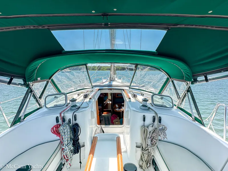 Slide: The Image of Cockpit view of 1999 Beneteau 411 sailboat with green canopy and ropes. - 8