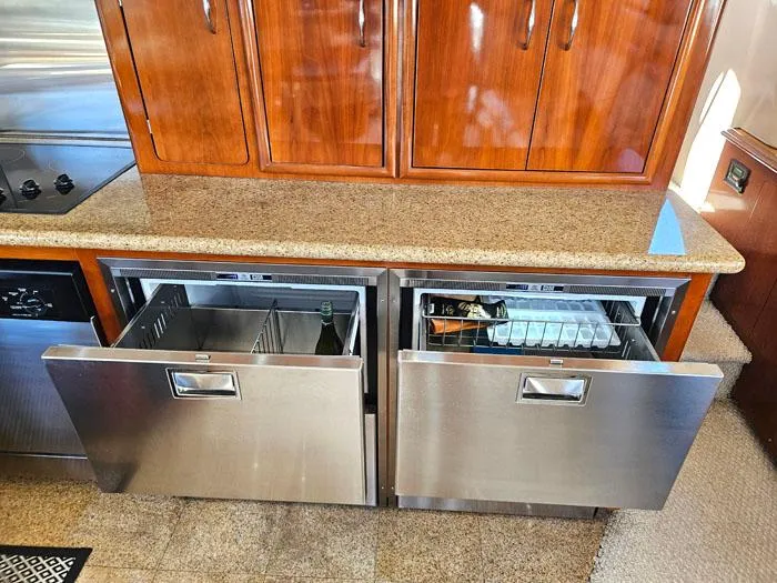 Slide: The Image of Stainless steel drawers in 2004 Carver 560 Voyager PH kitchen, featuring wooden cabinets and granite countertop. - 10