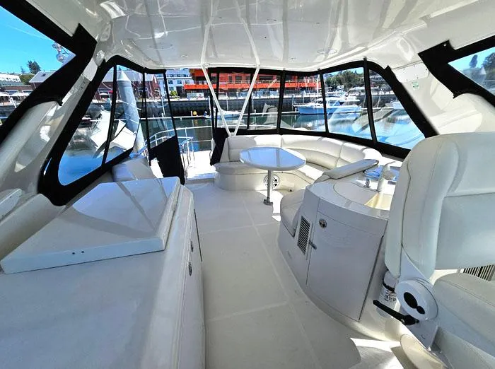 Slide: The Image of Luxurious interior of 2004 Carver 560 Voyager PH yacht with panoramic windows and seating. - 23