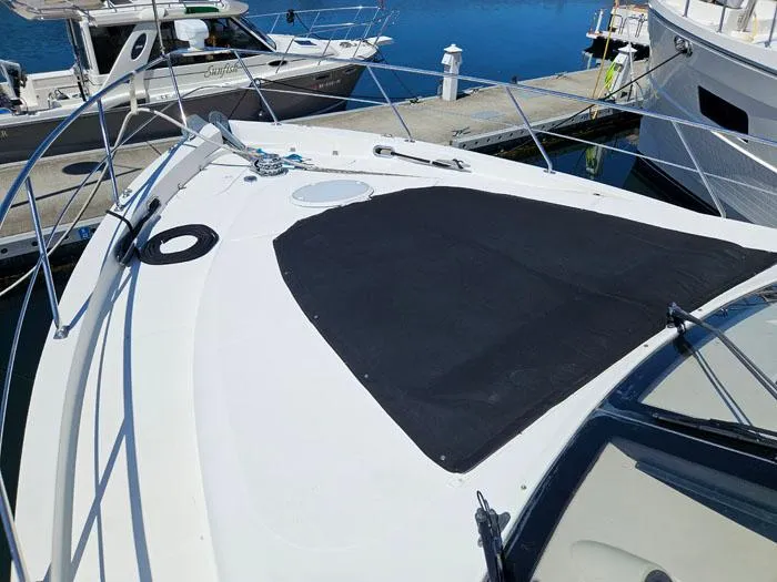 Slide: The Image of 2004 Carver 560 Voyager PH yacht docked at marina, featuring spacious deck and sleek design. - 34