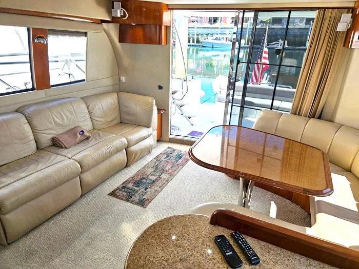 Slide: The Image of Luxurious interior of 2004 Carver 560 Voyager PH yacht with leather seating and dining area. - 7
