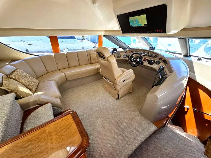 Slide: The Image of Luxurious interior of 2004 Carver 560 Voyager PH yacht with plush seating and modern helm. - 12