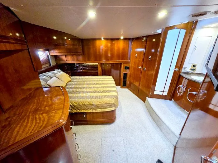 Slide: The Image of Luxurious interior of 2004 Carver 560 Voyager PH yacht with wood paneling and cozy bed. - 15