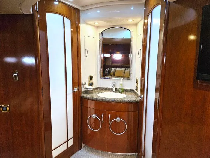 Slide: The Image of Luxurious bathroom in 2004 Carver 560 Voyager PH yacht with wood cabinetry and modern fixtures. - 16