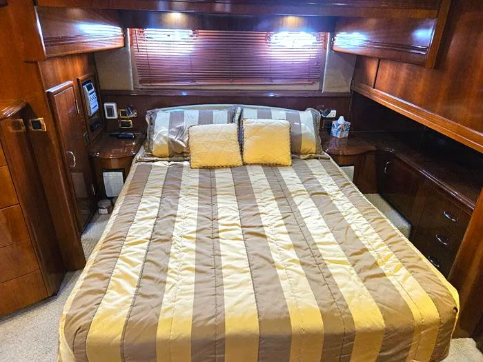Slide: The Image of Luxurious bedroom interior of 2004 Carver 560 Voyager PH yacht with striped bedding. - 17