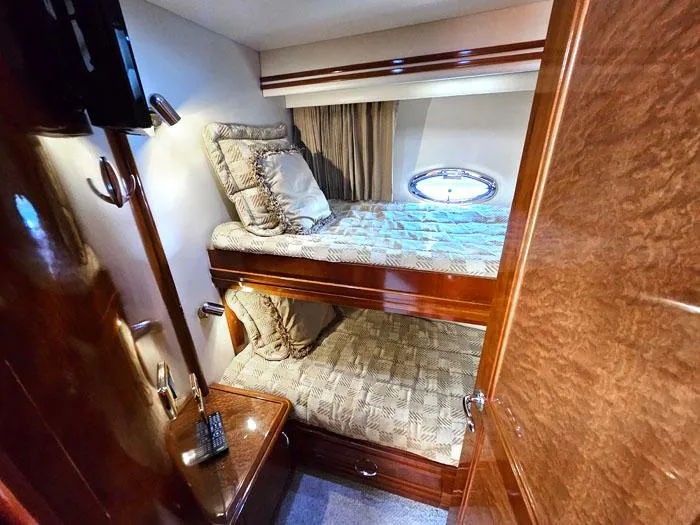 Slide: The Image of Luxurious cabin interior of 2004 Carver 560 Voyager PH with bunk beds and elegant wood finish. - 20