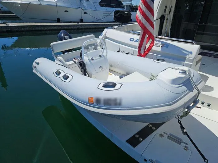 Slide: The Image of 2004 Carver 560 Voyager PH with inflatable dinghy docked at marina. - 32