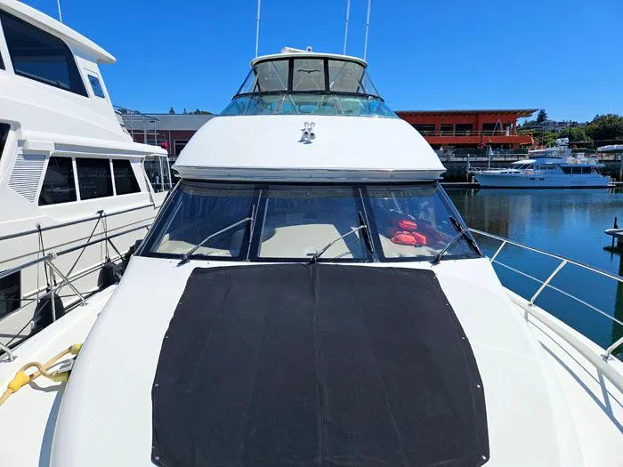 Slide: The Image of 2004 Carver 560 Voyager PH yacht docked at marina under clear blue sky. - 35