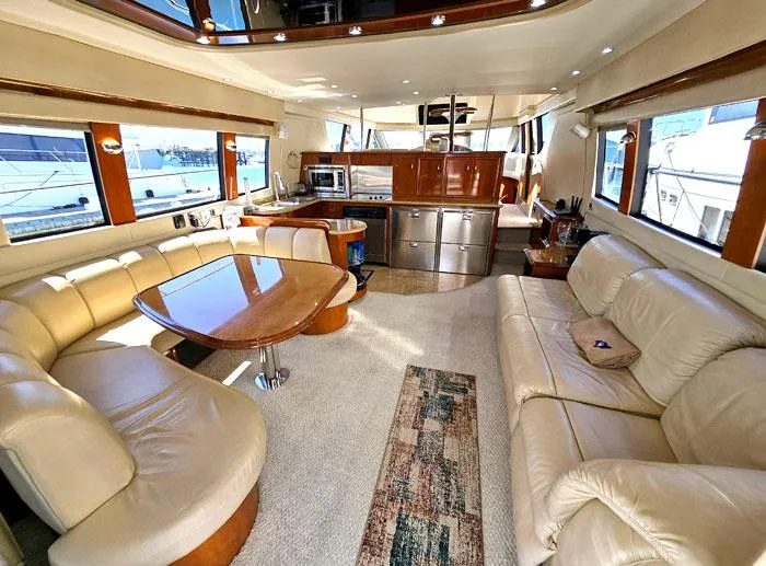 Slide: The Image of Luxurious interior of 2004 Carver 560 Voyager PH yacht with leather seating and modern kitchen. - 5