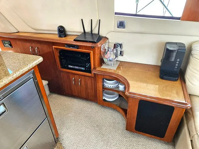 Slide: The Image of 2004 Carver 560 Voyager PH interior with wooden cabinetry, appliances, and modern amenities. - 8