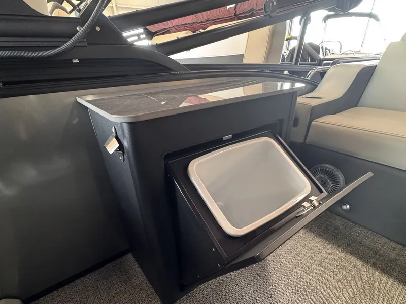 Slide: The Image of Interior of a 2026 Barletta Cabrio 24 UE featuring a built-in refrigerator. - 19