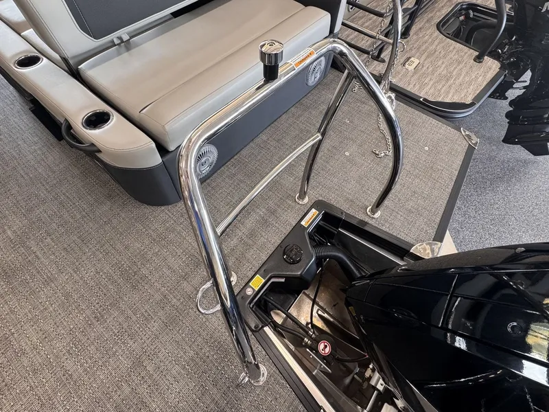 Slide: The Image of The image shows the interior of a Barletta Cabrio 24 UE boat with polished metal railings and an engine. - 30