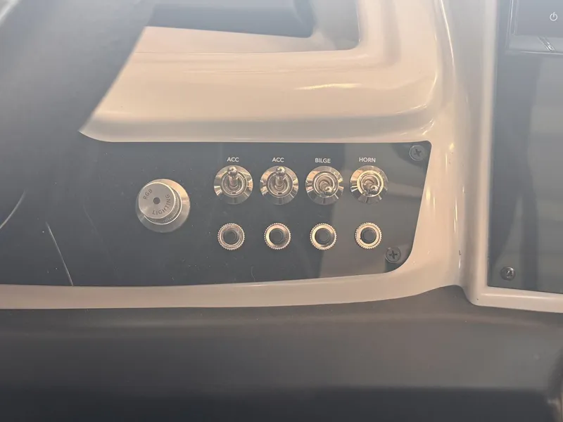 Slide: The Image of Close-up of a boat control panel with switches for accessories, bilge, and horn. - 14