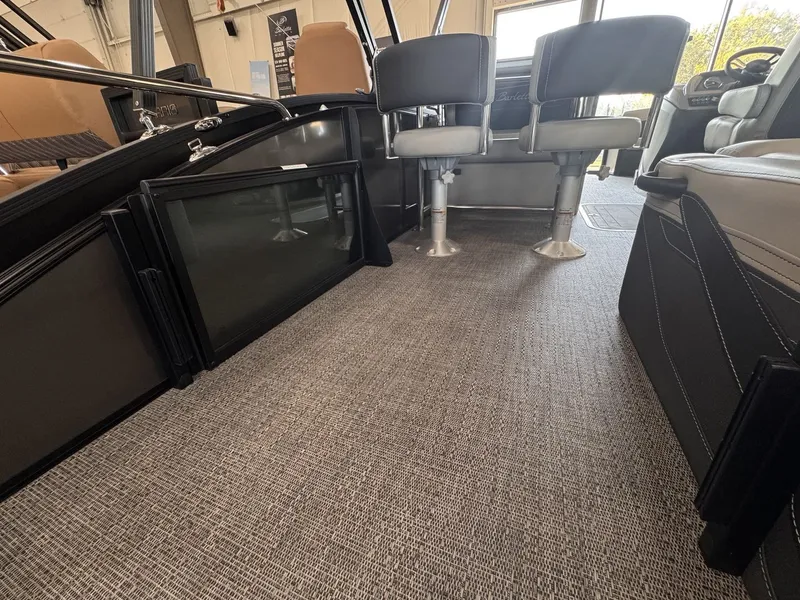 Slide: The Image of Interior of a 2026 Barletta Cabrio 24 UE with gray carpet flooring and comfortable seating. - 24