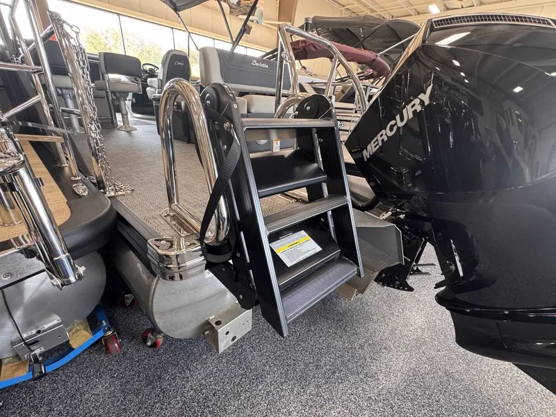 Slide: The Image of The 2026 Barletta Cabrio 24 UE features a sturdy boarding ladder and a powerful Mercury engine. - 34