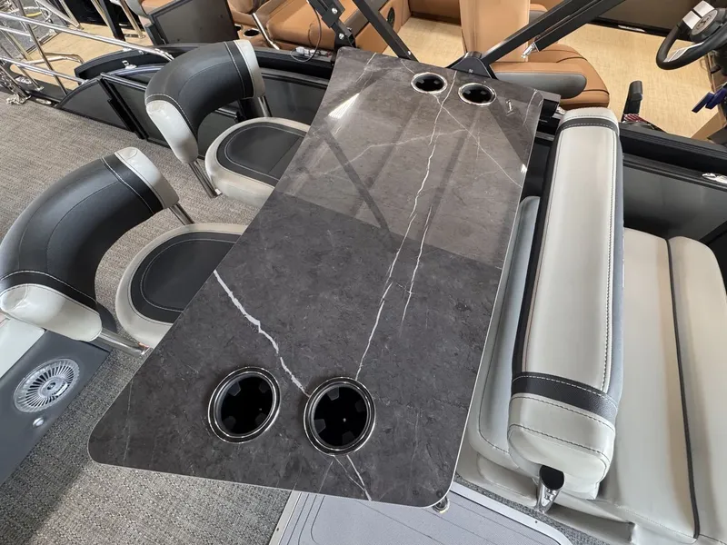 Slide: The Image of A sleek marble-look table with cup holders on a modern boat. - 21