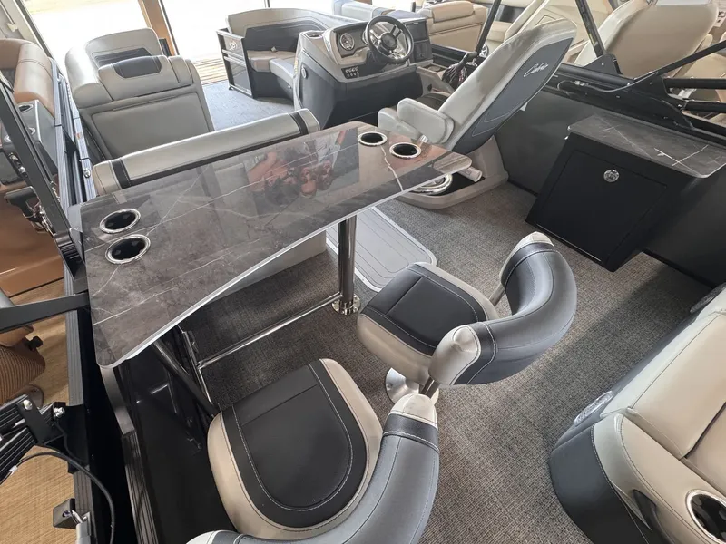 Slide: The Image of Interior of a 2026 Barletta Cabrio 24 UE with sleek seating and a table. - 23